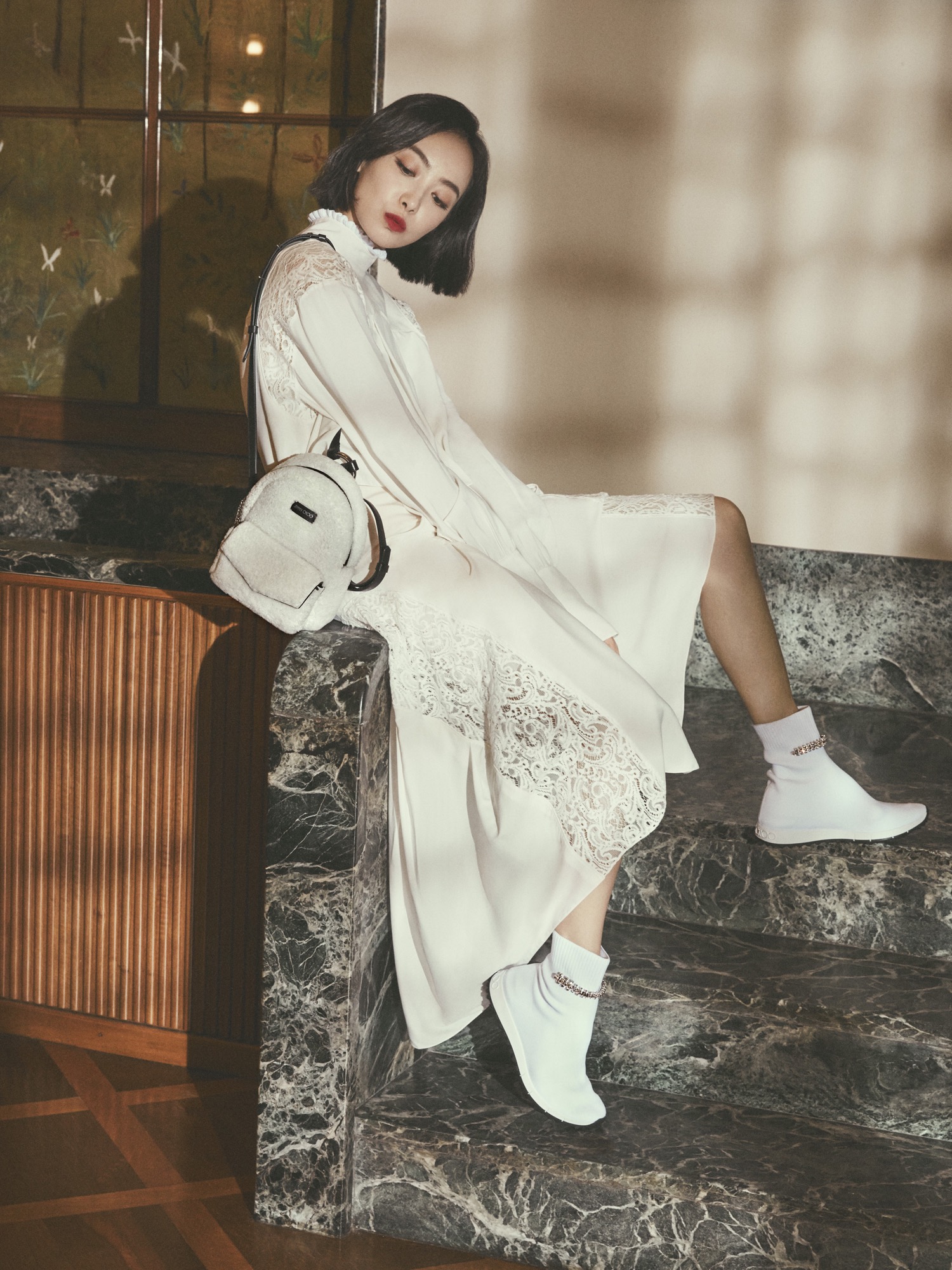 Victoria Song Qian carrying CASSIE bag and wearing REGENA trainers